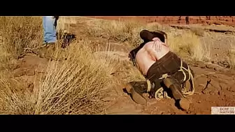 Monstrous-behind blonde gets her anus whipped, then gets rough anal sex in dirt and piss -- a real BDSM session outdoors in the Western USA with Rebel Rhyder